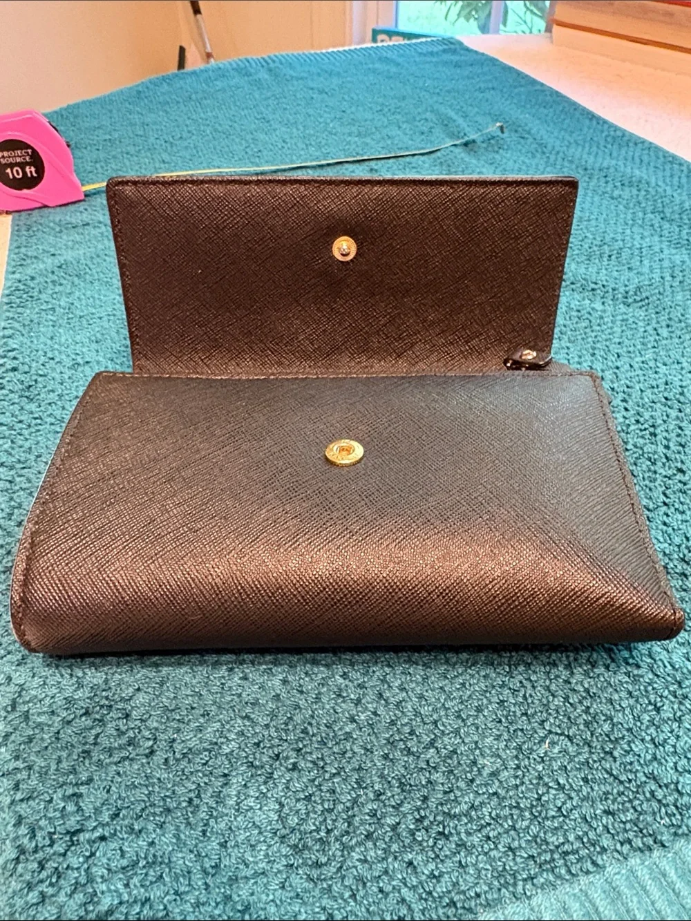 Kate Spade black saffiano tri-fold hand wallet with gold logo